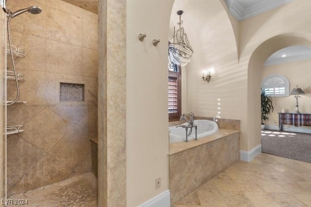 bathroom featuring ornamental molding and shower with separate bathtub