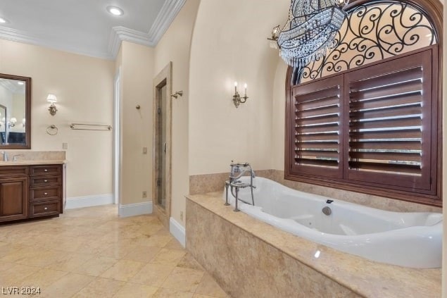 bathroom with ornamental molding, independent shower and bath, and vanity