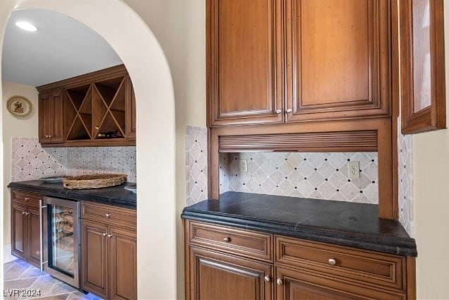 bar featuring wine cooler and backsplash