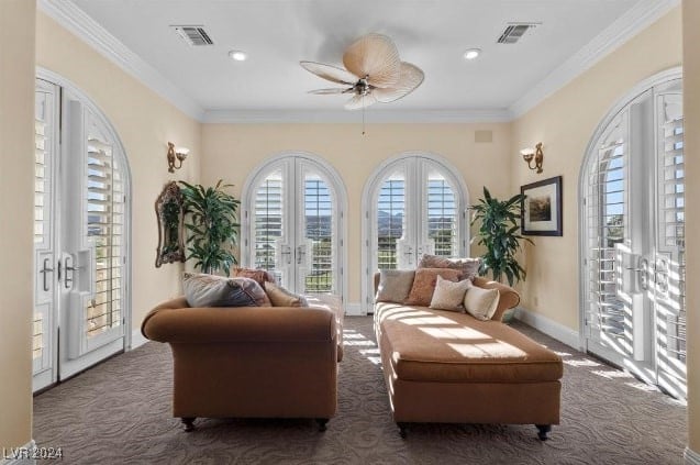 sitting room featuring dark carpet, ceiling fan, french doors, and crown molding