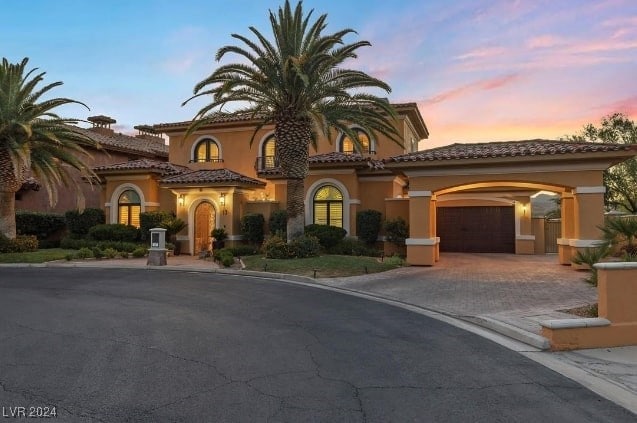 mediterranean / spanish house with a garage