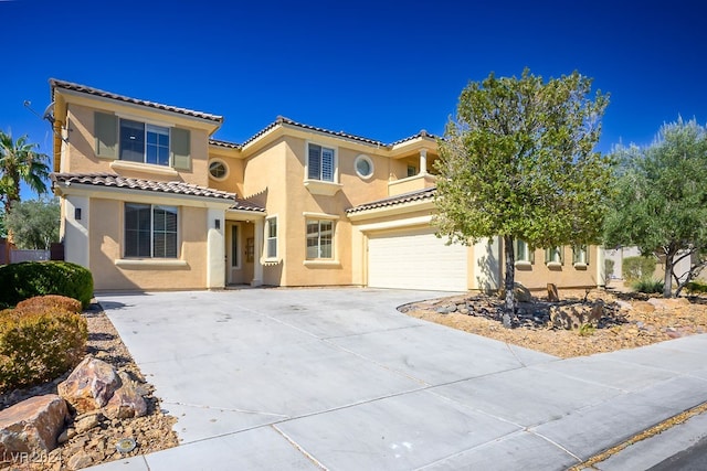 mediterranean / spanish-style home with a garage