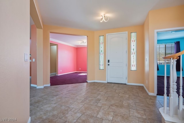 entryway featuring crown molding