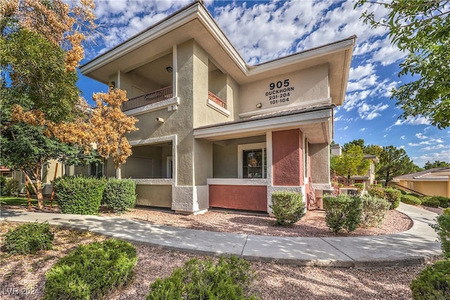 view of front of property with a balcony and covered porch