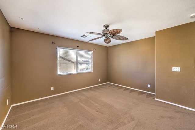 carpeted spare room with ceiling fan