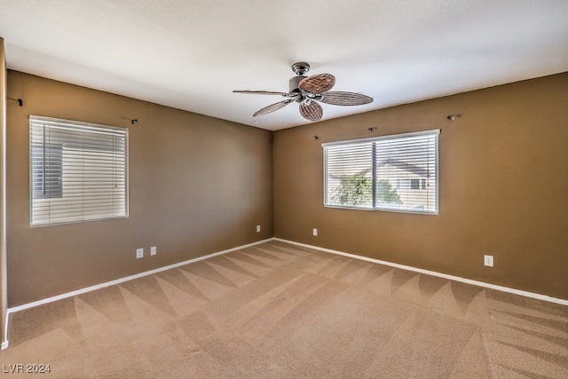 carpeted empty room with ceiling fan