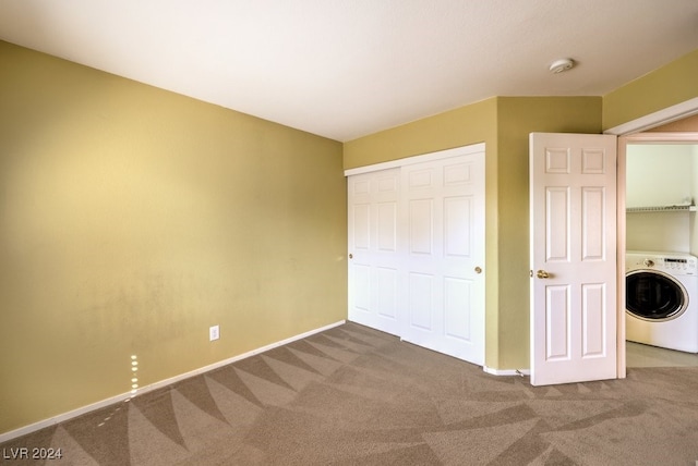 unfurnished bedroom featuring carpet, washer / clothes dryer, and a closet