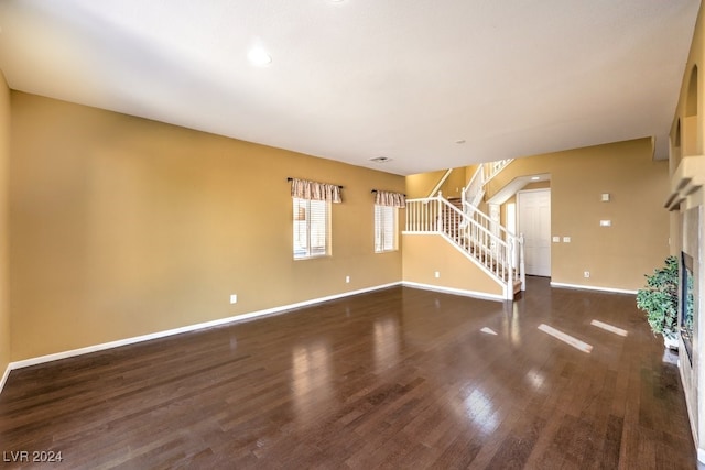 unfurnished living room with dark hardwood / wood-style floors