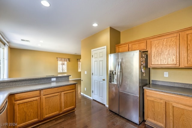 kitchen featuring stainless steel appliances and dark hardwood / wood-style floors