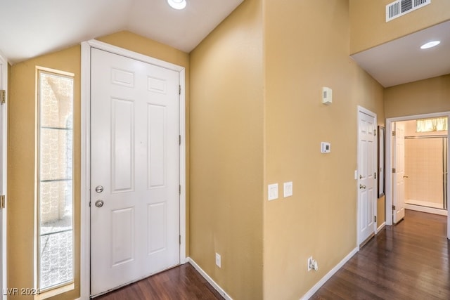 foyer entrance with vaulted ceiling and dark hardwood / wood-style floors