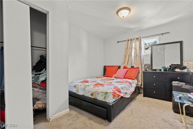 bedroom featuring a textured ceiling and carpet flooring