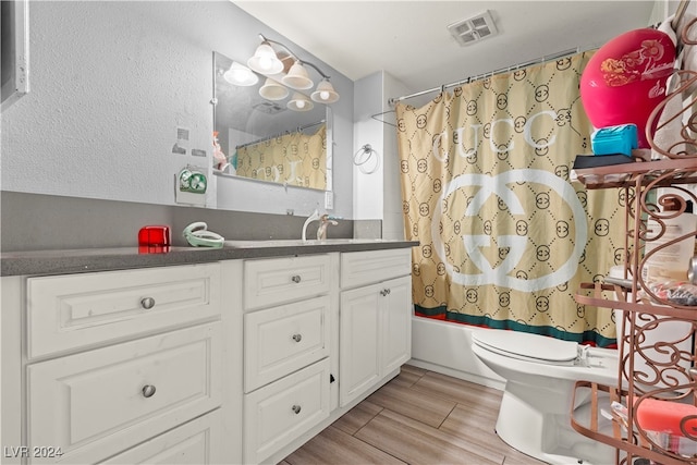 full bathroom with wood-type flooring, vanity, toilet, and shower / bath combo with shower curtain