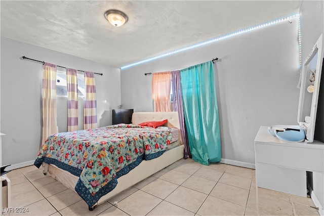 bedroom with light tile patterned floors