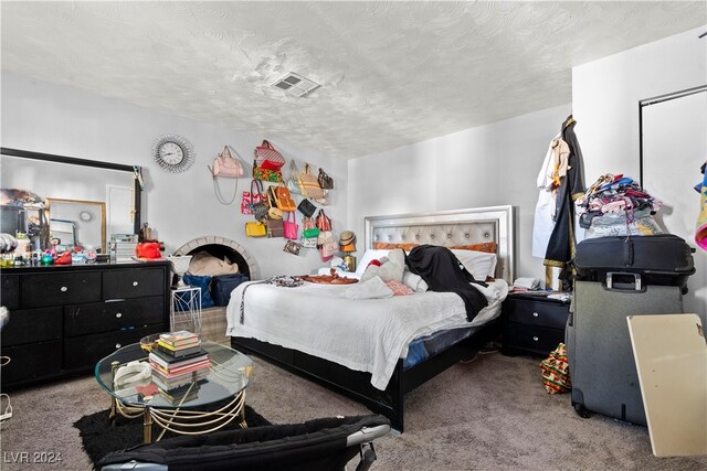 carpeted bedroom featuring a textured ceiling