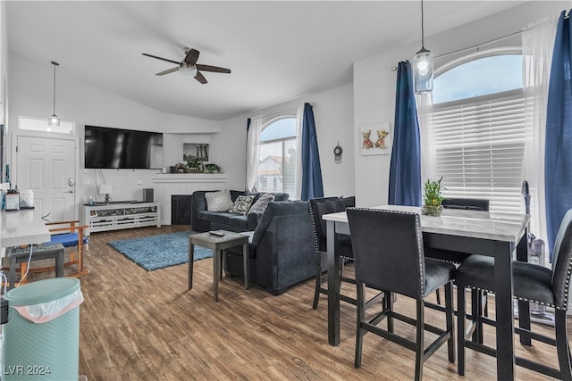 living room featuring ceiling fan, vaulted ceiling, and dark hardwood / wood-style flooring