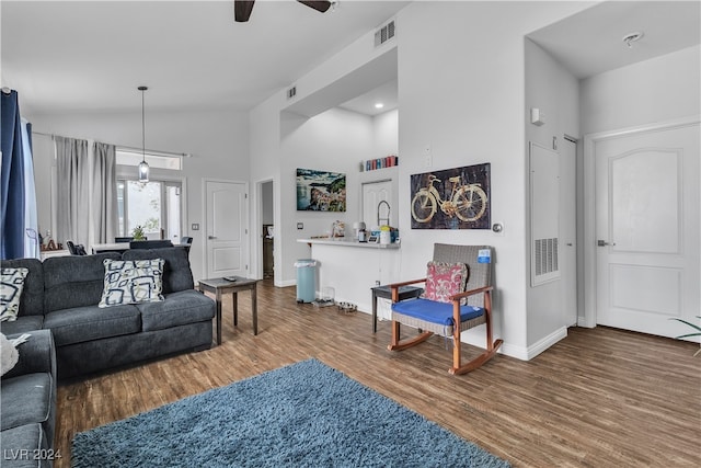 living room with high vaulted ceiling, ceiling fan, and wood-type flooring