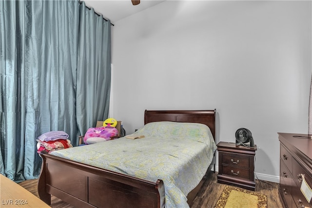 bedroom with ceiling fan and dark hardwood / wood-style flooring