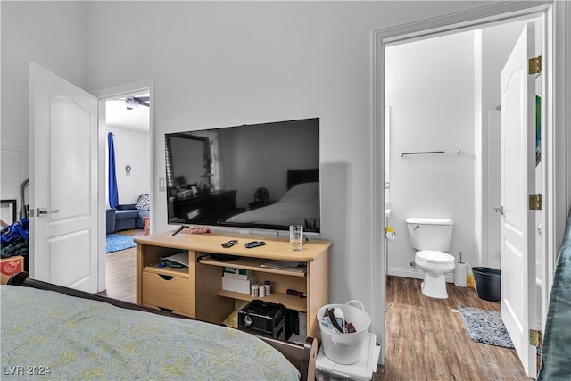 bedroom with wood-type flooring and ensuite bathroom