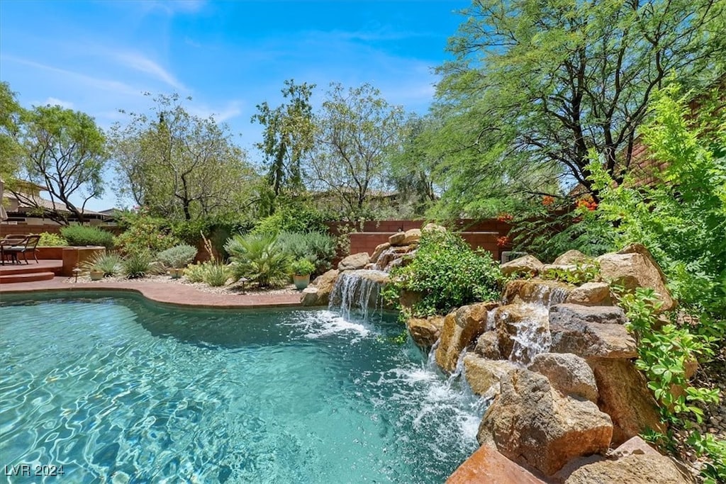 view of swimming pool featuring pool water feature