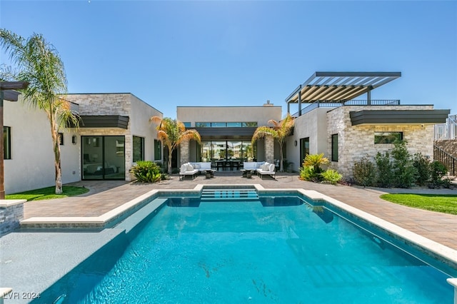 rear view of house with a patio and outdoor lounge area