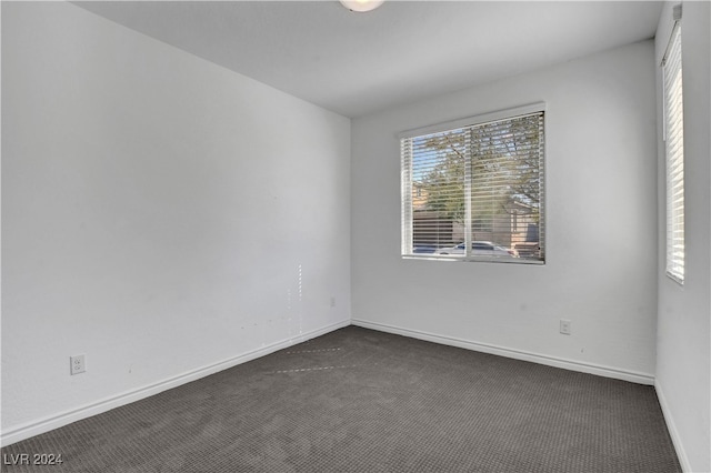 empty room featuring dark colored carpet