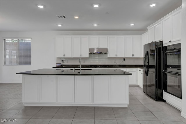 kitchen featuring black appliances, white cabinetry, and a kitchen island with sink