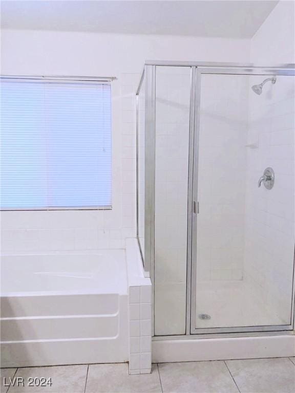 bathroom featuring tile patterned flooring and independent shower and bath