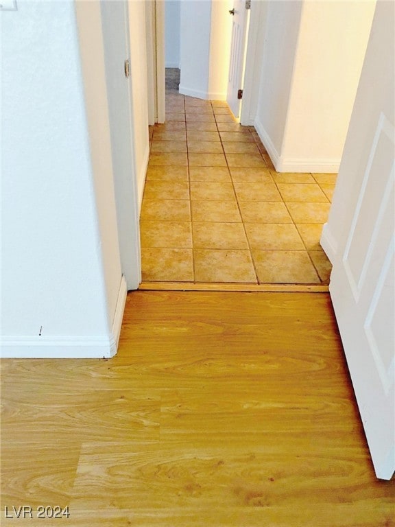 hall with light tile patterned floors