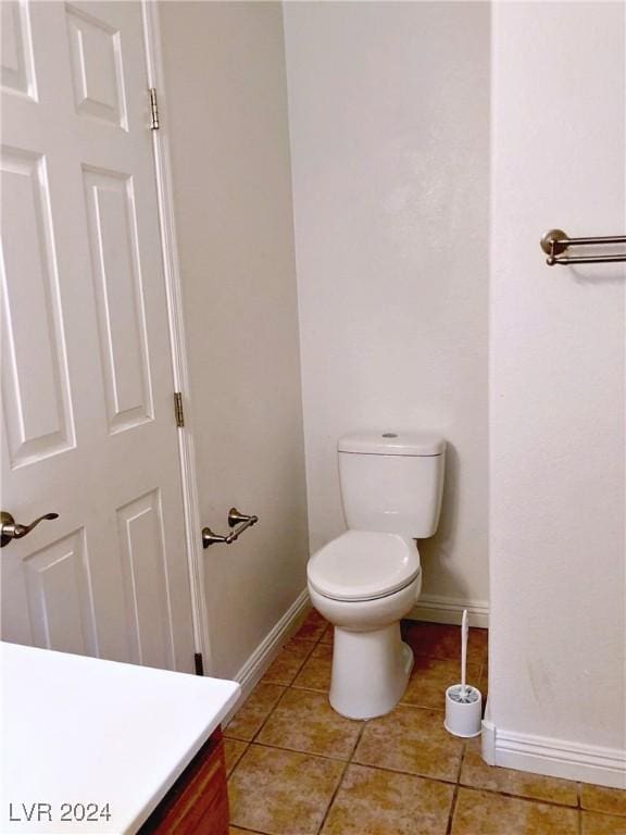 bathroom featuring tile patterned flooring, vanity, and toilet