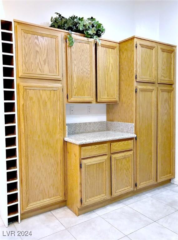 kitchen featuring light stone counters and light tile patterned floors