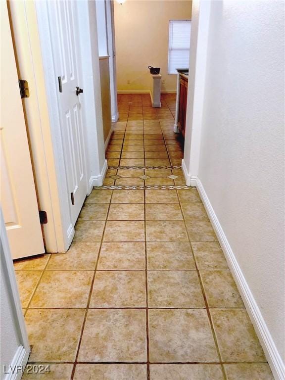 hallway featuring light tile patterned flooring