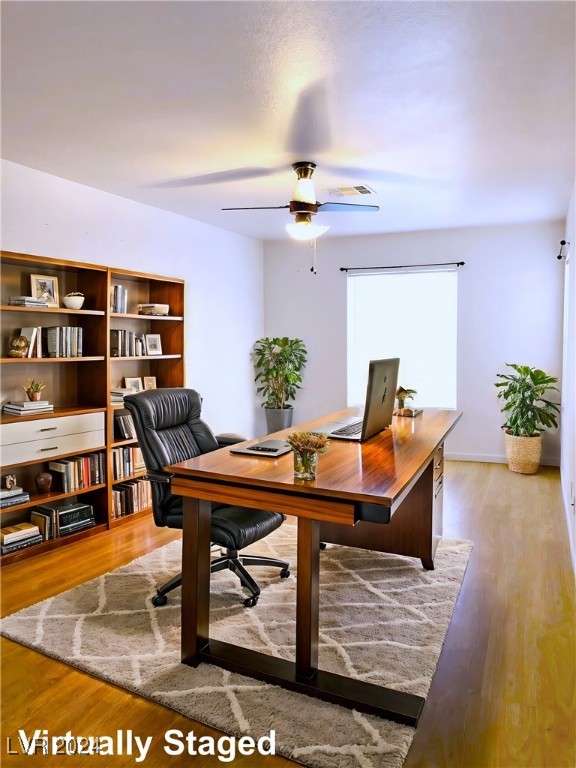 office space with light hardwood / wood-style floors and ceiling fan