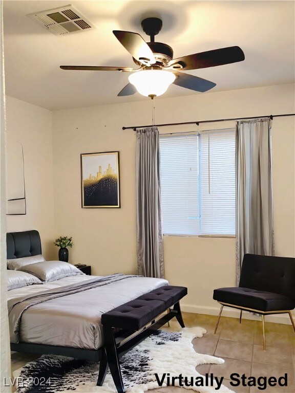 bedroom with ceiling fan and light tile patterned floors