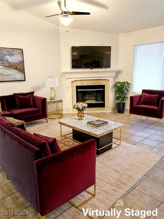 tiled living room with ceiling fan and a premium fireplace