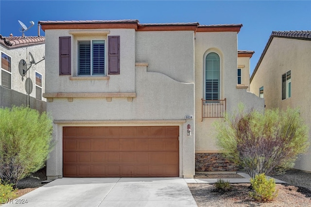 mediterranean / spanish-style house with a garage