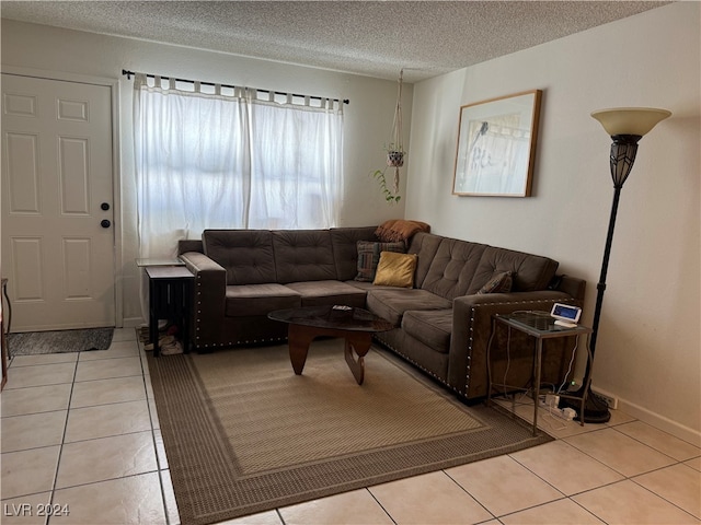 living room featuring a textured ceiling and light tile patterned floors