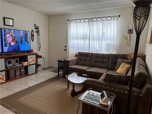 tiled living room featuring a textured ceiling