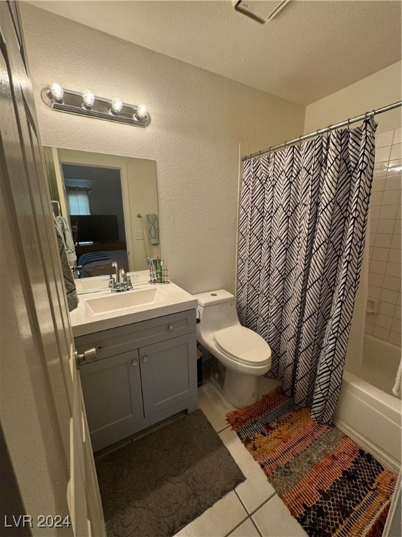 full bathroom with vanity, toilet, a textured ceiling, shower / tub combo, and tile patterned flooring