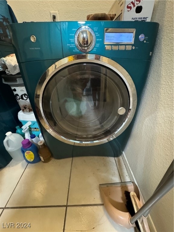 washroom featuring tile patterned flooring and washer / dryer