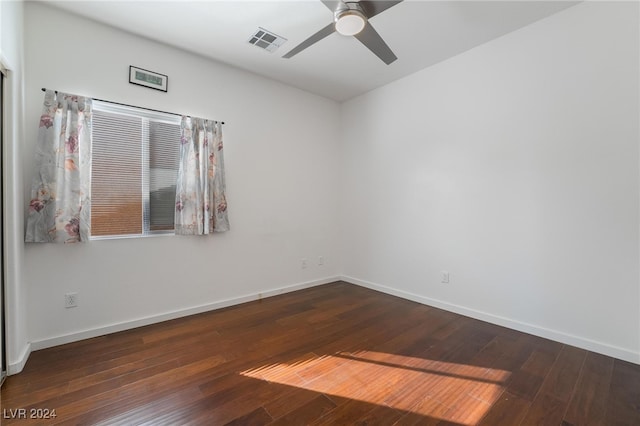 empty room featuring ceiling fan and dark hardwood / wood-style flooring