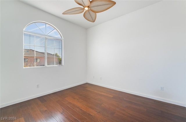 unfurnished room featuring ceiling fan and dark wood-type flooring