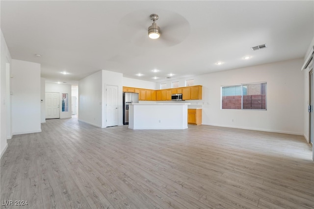 unfurnished living room featuring ceiling fan and light hardwood / wood-style flooring