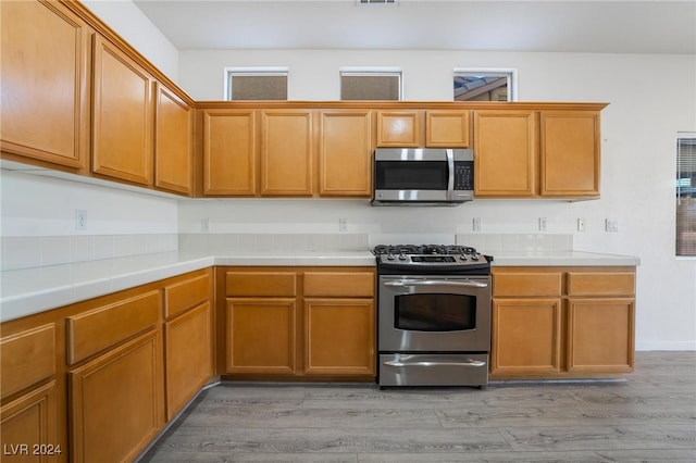 kitchen with light hardwood / wood-style floors and stainless steel appliances