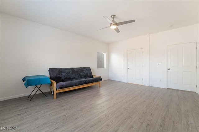 living area with ceiling fan and light hardwood / wood-style floors