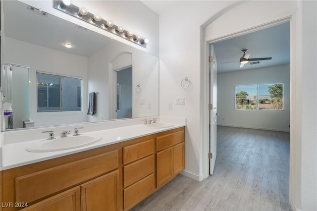 bathroom with wood-type flooring, vanity, and ceiling fan