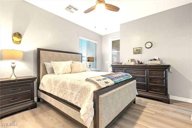 bedroom with light hardwood / wood-style floors and ceiling fan