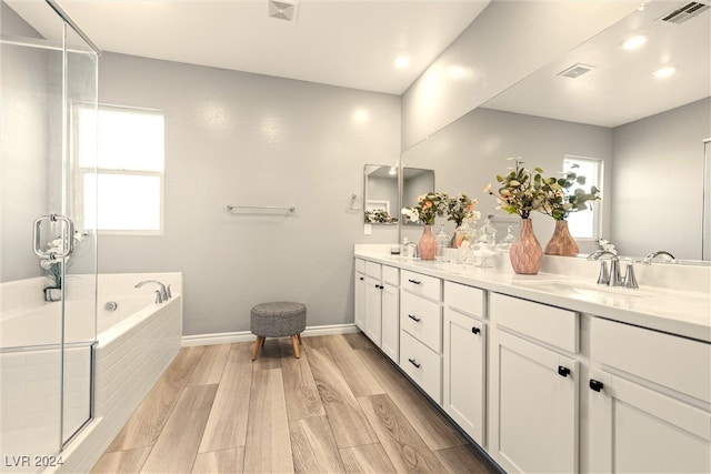 bathroom featuring independent shower and bath, vanity, and hardwood / wood-style flooring