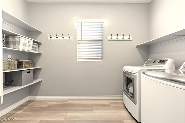 washroom with light hardwood / wood-style floors and separate washer and dryer