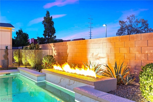 view of pool at dusk