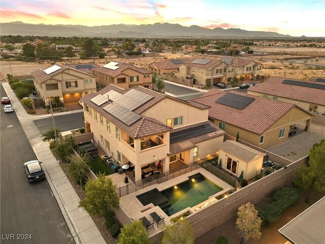 aerial view at dusk featuring a mountain view